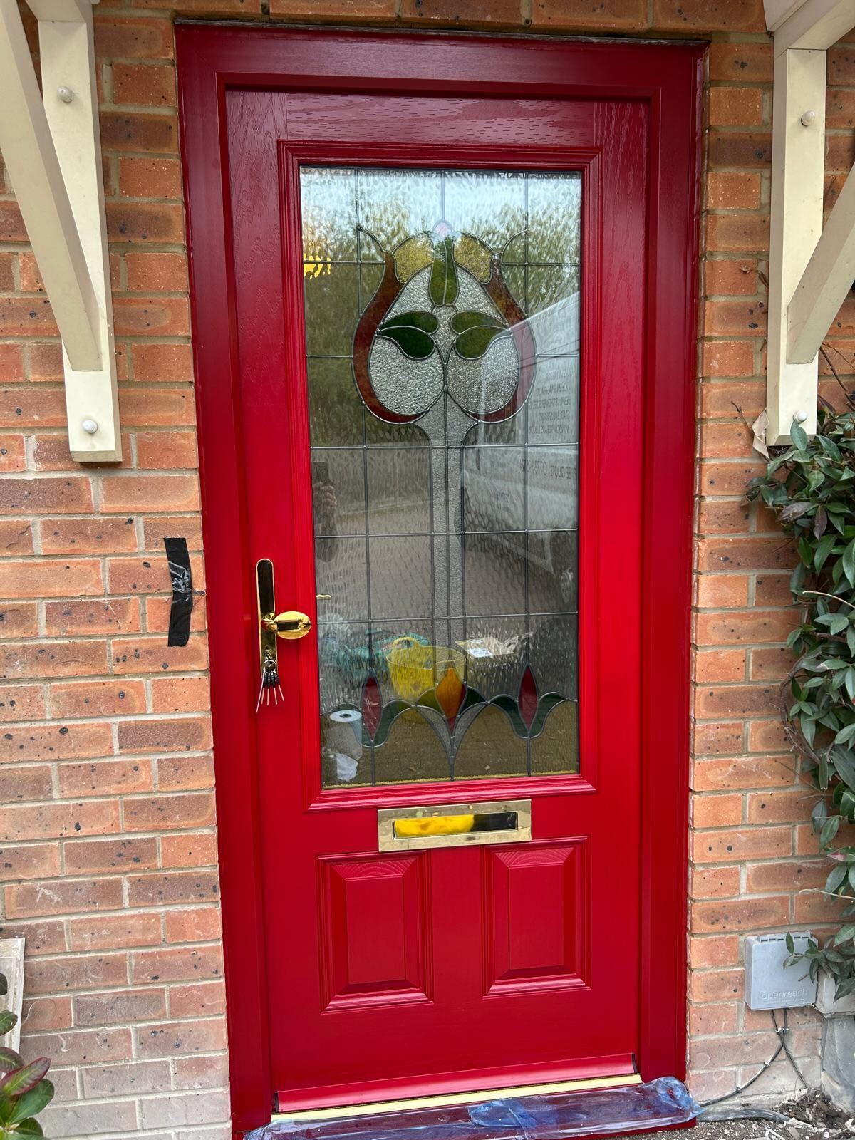 Red front door with traditional leaded light fitted in Hillingdon by IM Glass